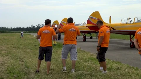 Five pilots among which one woman is practicing group aerobatics on ground. 動画素材 121203578