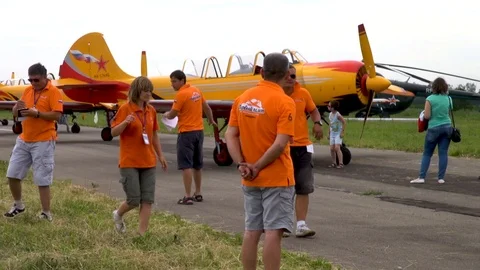 Five pilots among which one woman is practicing group aerobatics on ground. Stock Footage 121203624