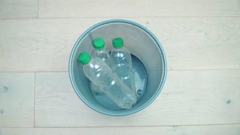 Five plastic bottles in turn fall into the office trash can 库存影片 151762481