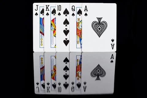 Five playing suits of peak suit on a dark background Stock Photos