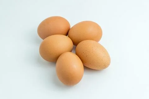 Five raw brown chicken eggs isolated on a pure white background Stock Photos