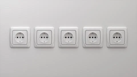 Five Realistic White Type F Socket on White Wall. 3D Render. Stock Illustration