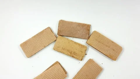 Five rectangular crispy wafer cookies scattered on a bright white surface Stock Footage 327117389