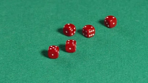 Five red dices rolling in slow motion on a green mat Stock Footage 161035834
