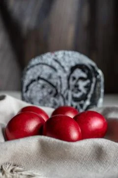 Five red-dyed Easter eggs, placed in a basket with a cream cotton napkin Stock Photos