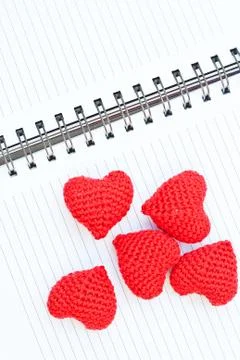 Five red knit hearts Stock Photos