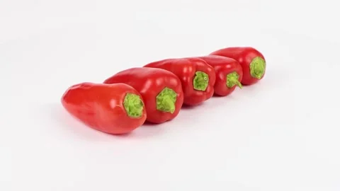 Five red sweet peppers on white background. Stock Footage 170794301