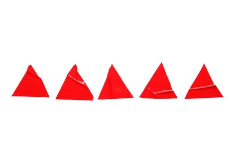 Five red triangular adhesive stickers with peeled corners arranged in a row o Stock Photos