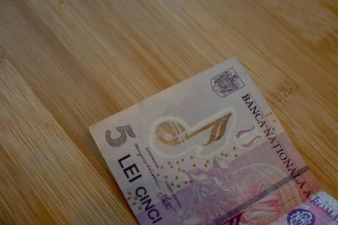 Five Romanian Leu Banknotes on Table, Financial Pressure Concept Photos