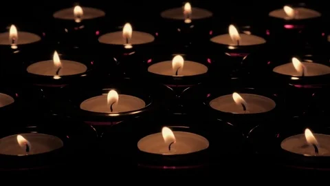 Five Rows of tealight candles with flickering flames Stock Footage 73955292