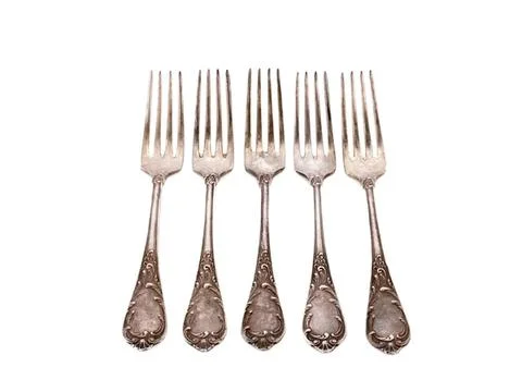Five silver forks with decorative handles on white background Stock Photos
