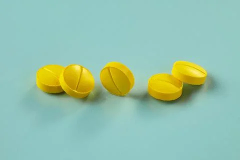 Five small yellow tablets Stock Photos