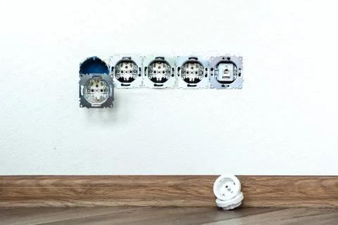 Five sockets installed in the white wall Foto stock
