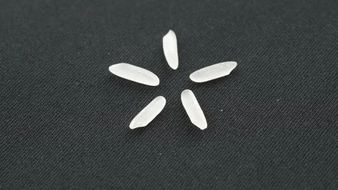 Five ST25 Rice Grains in Star Shape Rotating Top View Seamless Loop Stock Footage 321263871