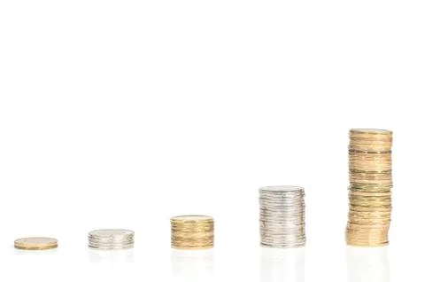 Five stacks of coins forming steps up isolated on white background Stock Photos