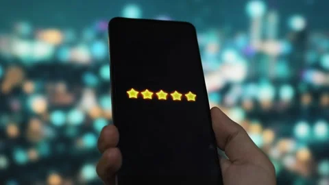 Five star rating displayed on smartphone screen indicating average customer Stock Footage 340510061