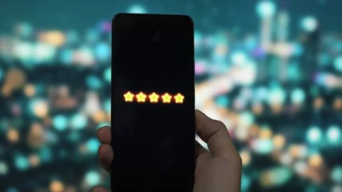 Five star rating displayed on smartphone screen indicating average customer Stock Footage 340510080