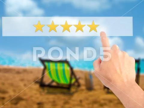 Five star rating - Hand pressing a button on blurred background Stock Photos