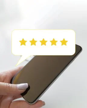 Five-star review of a mobile device shown on a smartphone screen held by a hand Stock Photos