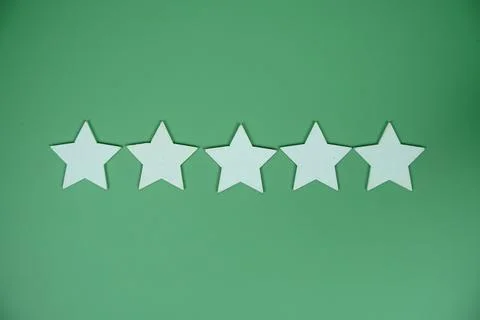 Five Star top view on green background, customer rating and feedback concept Stock Photos
