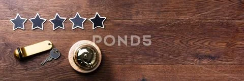 Five Stars, Service Bell And Hotel Key On Wooden Desk Stock Photos