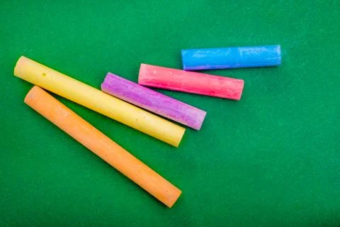 Five stick of Chalk on Green Stock Photos