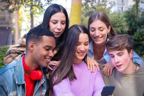 Five students having fun with mobile phones creating content on social media. Stock Photos