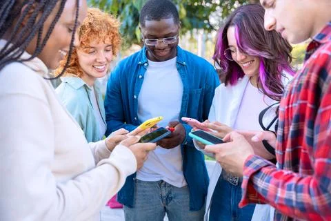 Five students having fun with mobile phones creating content on social media. Stock-Fotos