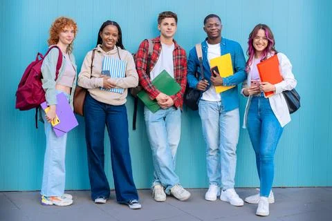 Five students having fun with mobile phones creating content on social media. Stock Photos