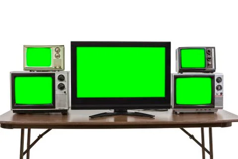 Five Televisions on Table Isolated on White with Chroma Green Screen Inserts Stock Photos