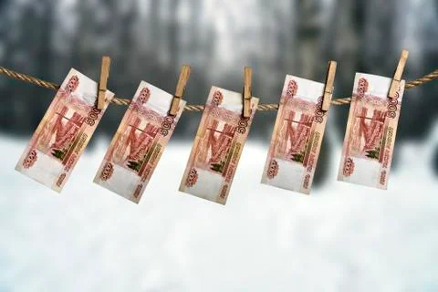 Five thousand russian rouble banknotes hanging on a clothesline with clothes Stockfoto's