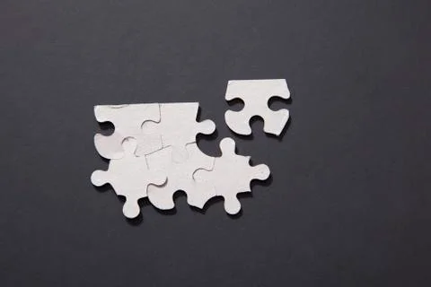 Five together puzzle pieces except one Foto stock