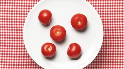 Five tomatoes on a rotating plate Stock Footage 8570800
