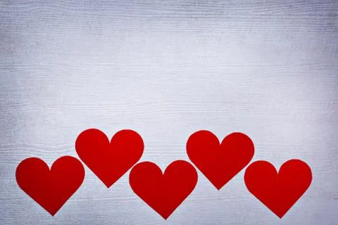 Five valentines hearts lined in a row on white wooden boards with place for text Stock Photos