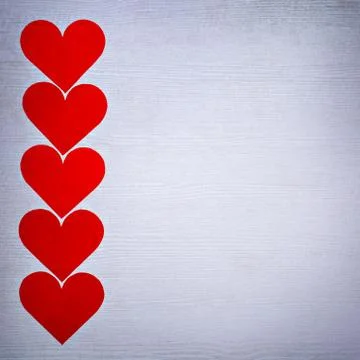 Five valentines hearts lined in a row on white wooden boards with place for text Stock Photos