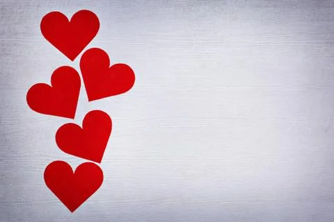 Five valentines hearts lined in a row on white wooden boards with place for text Stock Photos