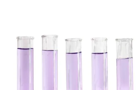 Five violet test tubes Foto stock