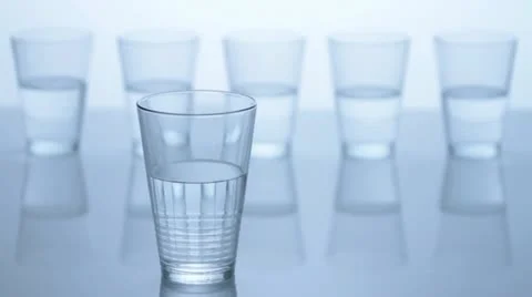 Five water glasses, one in front, four in the back Video stock 11606399