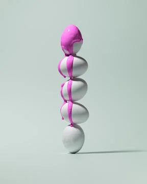 Five white eggs are stacked in a vertical column, with the top egg covered in 스톡 사진