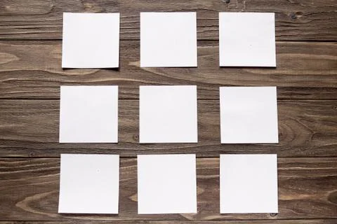 Five white post-in notes on wooden background Stock Photos