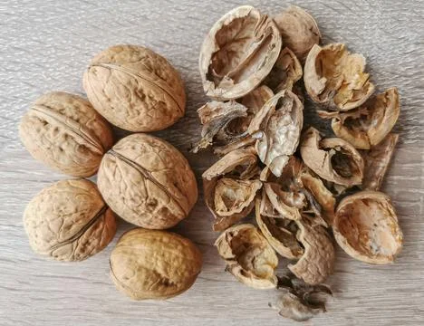 Five whole walnuts and nutshell Stock Photos