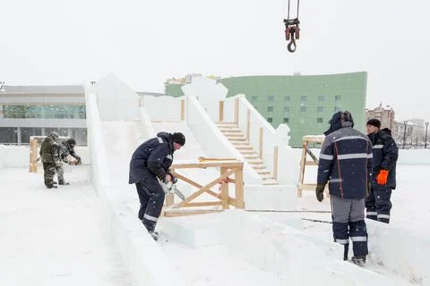 Five workers on the installation of the ice town 스톡 사진