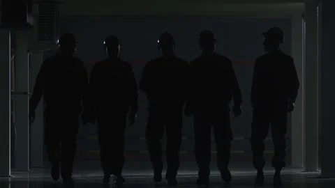 Five workers in work uniforms walk along a dark corridor 스톡 동영상 162902239