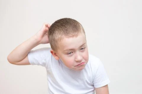 Five year old boy with a funny facial expression Stock Photos
