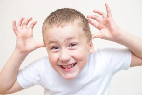 Five year old boy with a funny facial expression Stock Photos