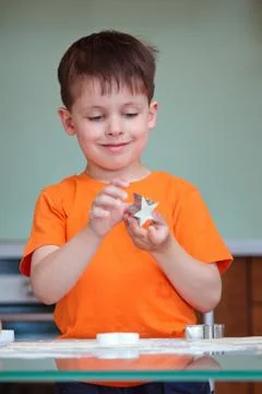 Five year old boy helps his mother make cookies Stock Photos