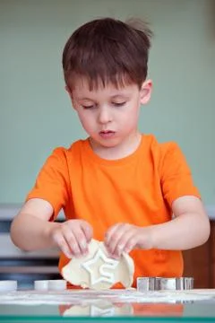 Five year old boy helps his mother make cookies Foto stock
