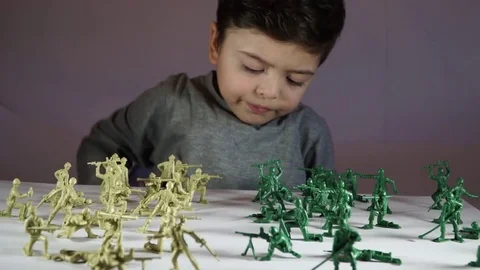 Five year old boy playing with toy soldiers Stock Footage 82489518