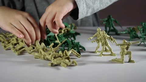 Five year old boy playing with toy soldiers Stock Footage 82489635