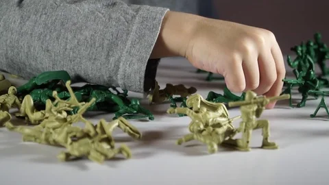 Five year old boy playing with toy soldiers Stock-Footage 82489663